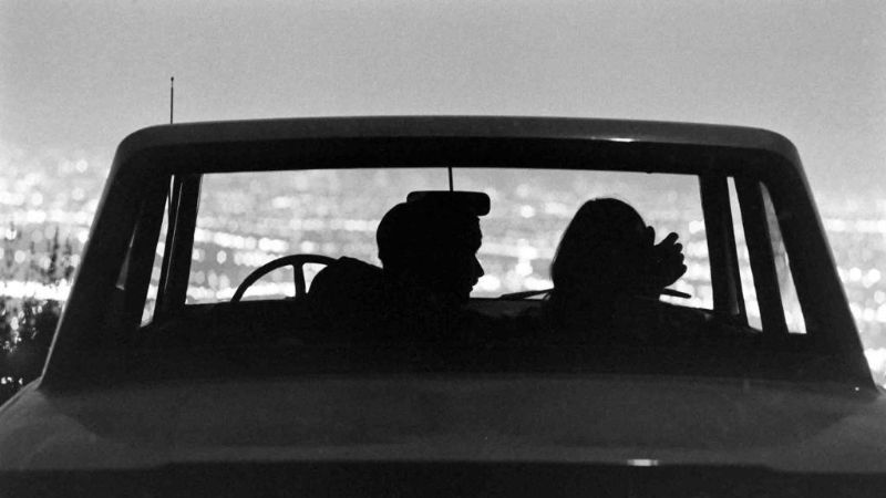 couple looking out car at the ocean