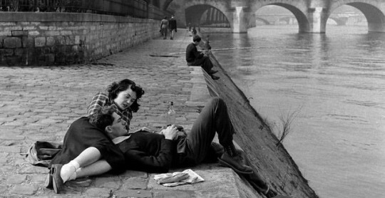 guy and girl laying by river talking