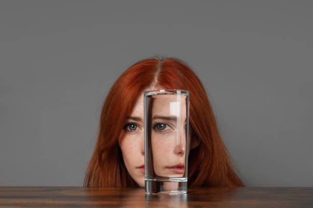 girl looking through a glass of water