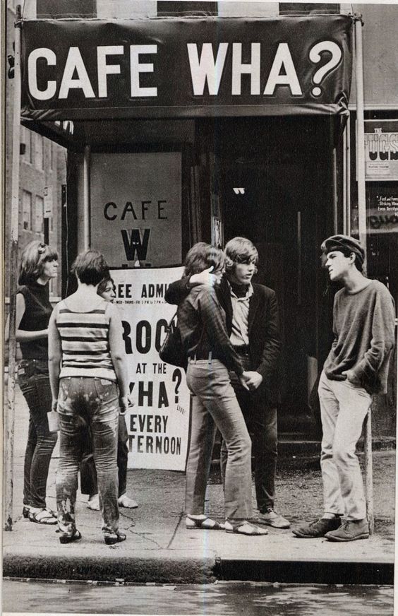 group of guys chatting outside a store 1960s