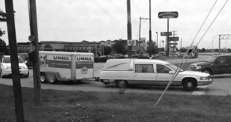 a UPS truck following a hurse