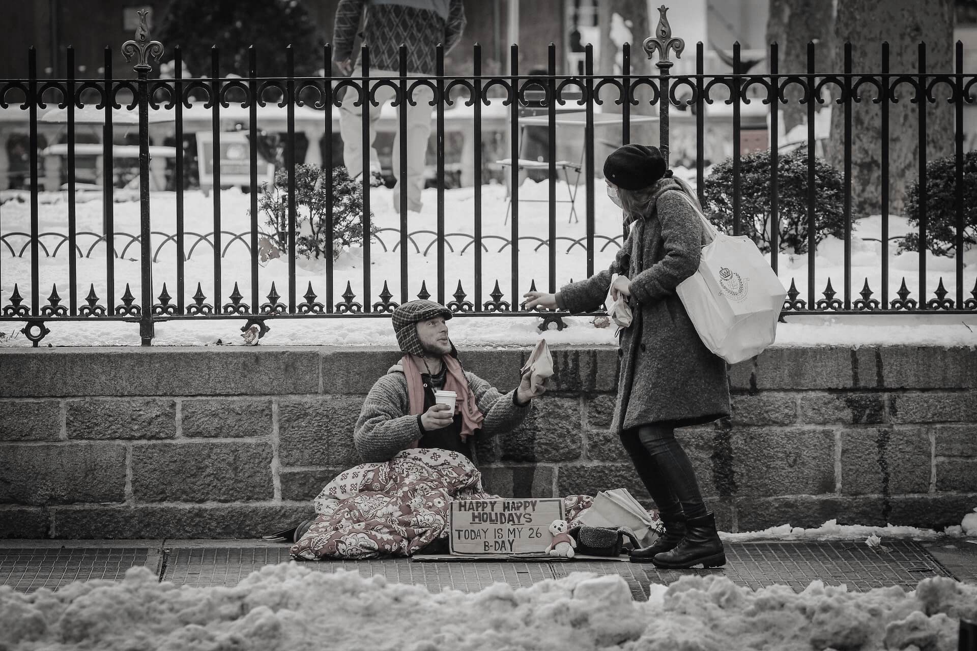 photo of a woman being kind giving to a homeless person