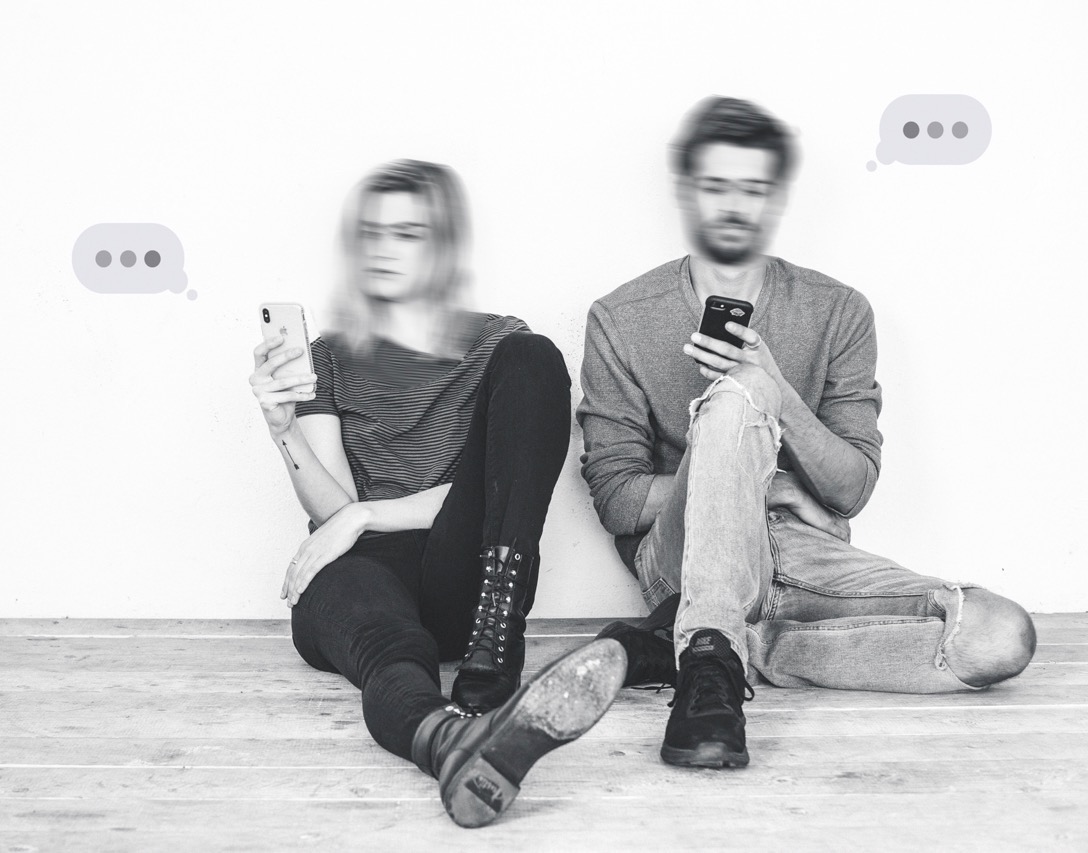 a couple staring at their phones